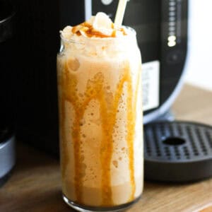 ninja slushi caramel frappuccino in the glass on the table