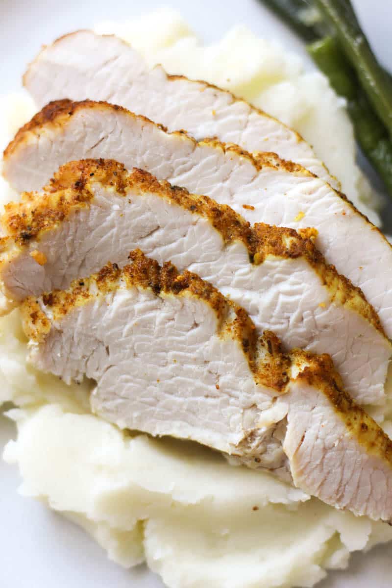 sliced turkey breast on top of mashed potatoes