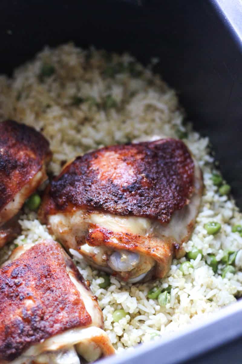 chicken thighs in ninja speedi on top of rice with green peas