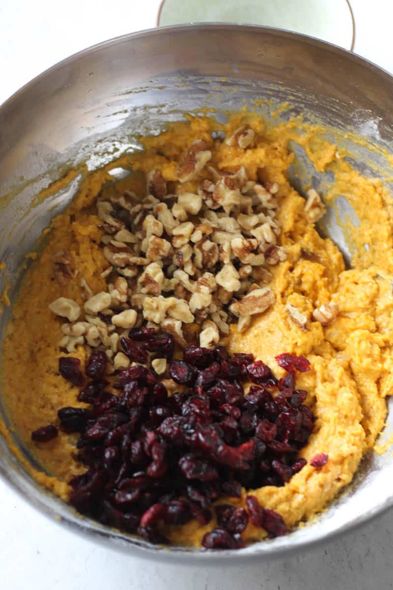 batter topped with dried cranberries and chopped walnuts