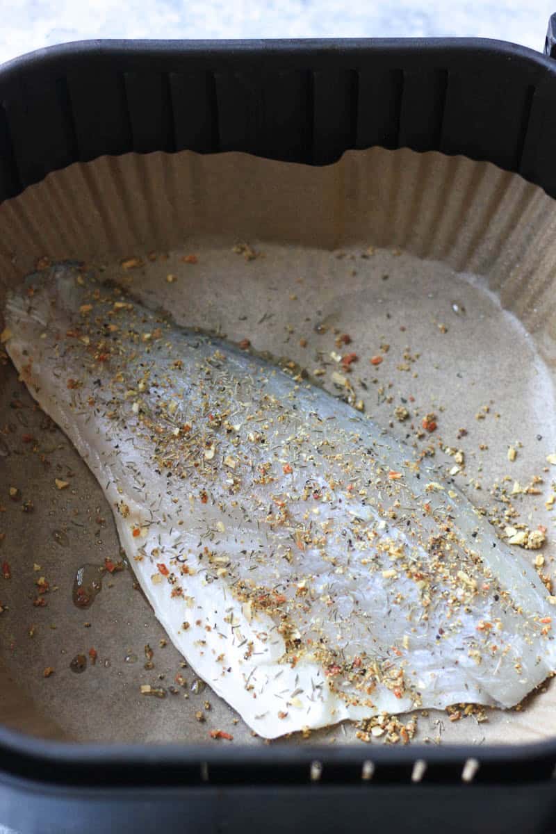 raw seasoned fish fillet in air fryer