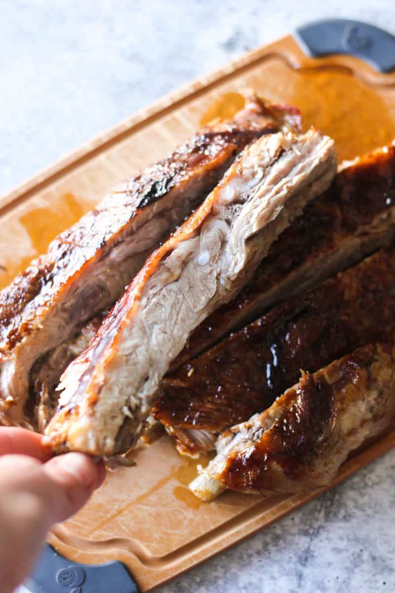 holding pork rib in hand