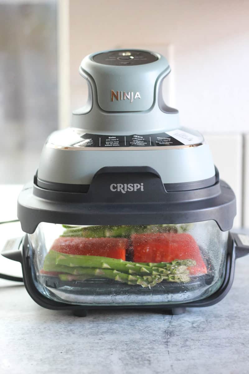 raw salmon pieces in ninja crispi air fryer
