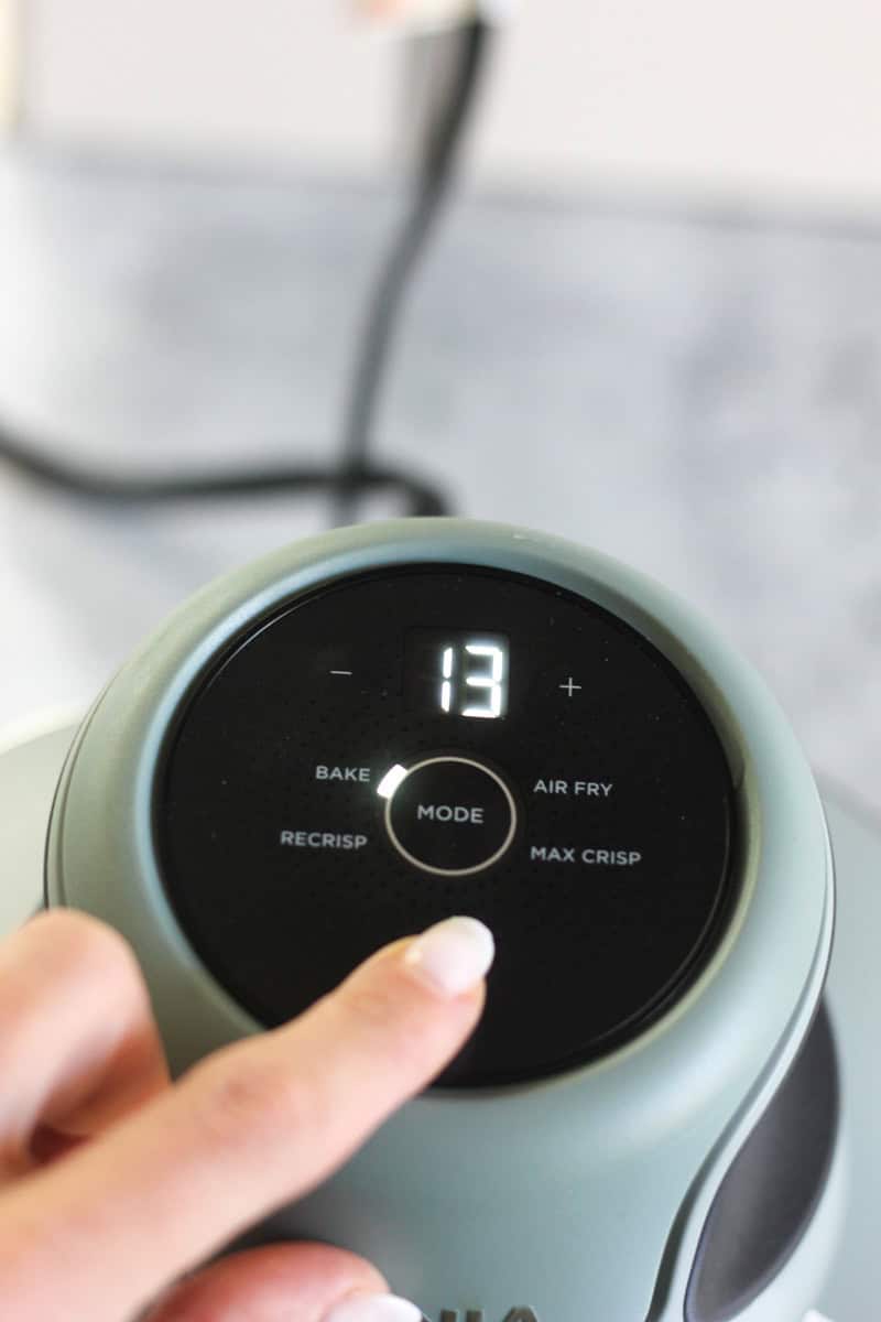 Digital air fryer control panel showing temperature and mode settings.