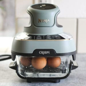 Egg cooker with eggs, modern kitchen appliance for breakfast and meal prep.