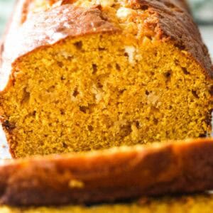 Close-up of a moist pumpkin bread slice with a golden crust.