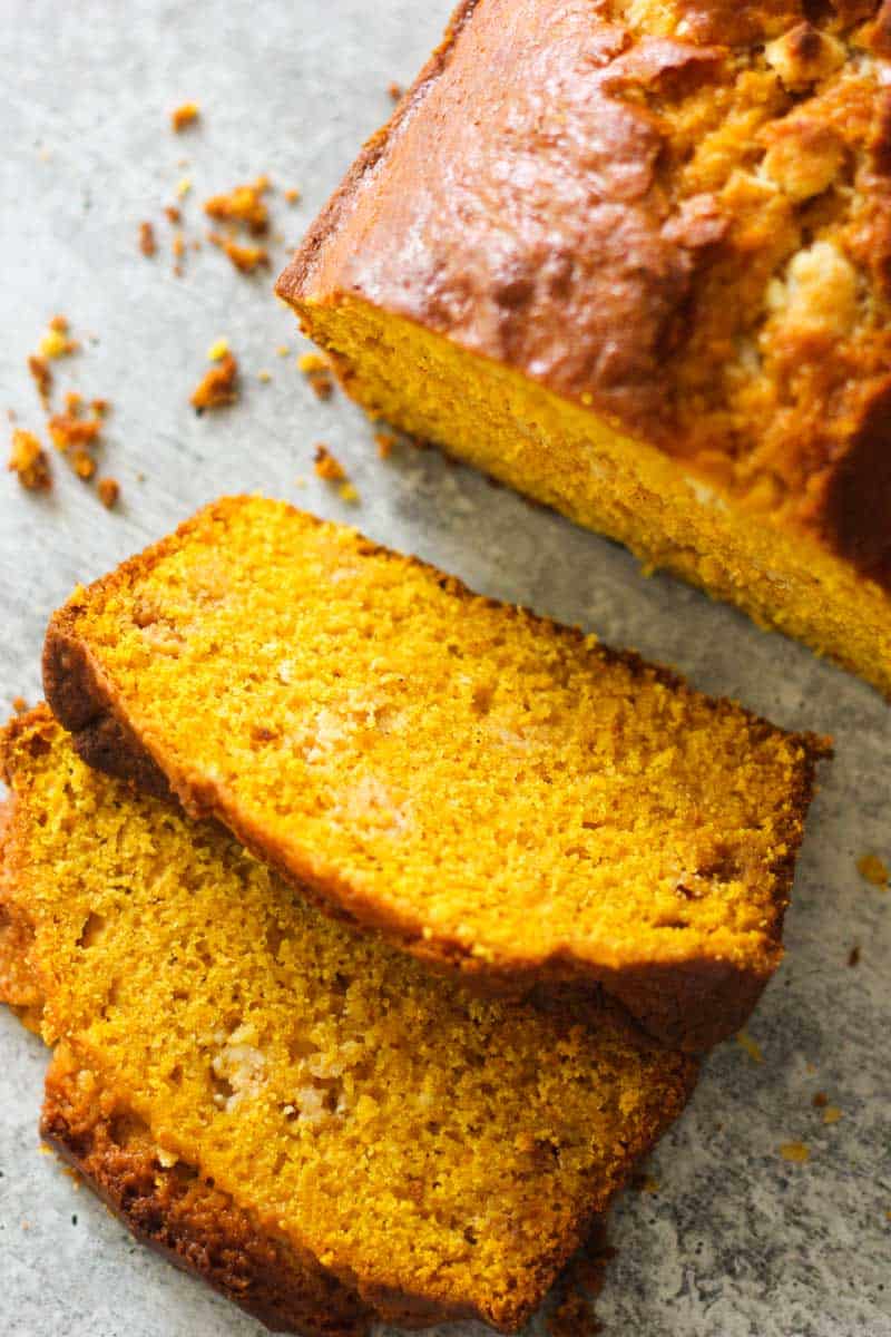 Freshly baked cornbread loaf sliced to reveal moist interior.