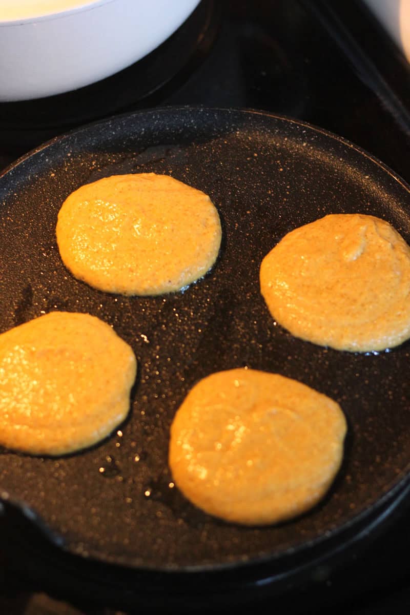 Pancakes cooking on a skillet, golden and fluffy, ready to serve.