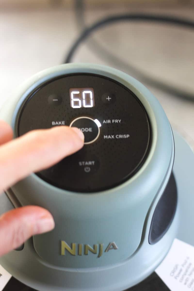 Ninja Foodi pressure cooker with digital display showing 60 minutes.