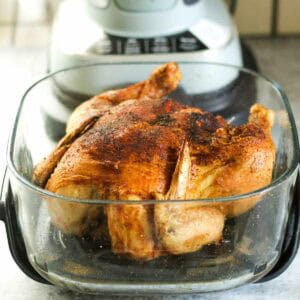Juicy roasted chicken in a glass baking dish ready to serve.