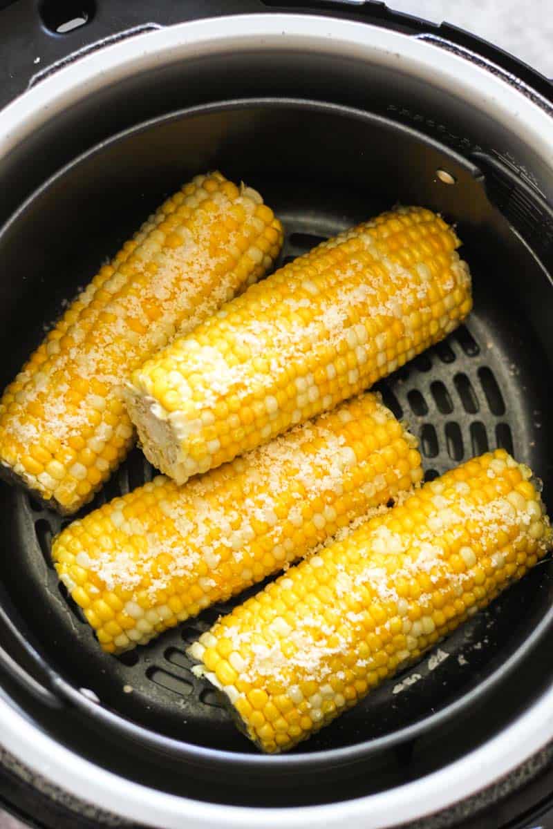 Golden corn on the cob cooked in an air fryer, ready to serve.