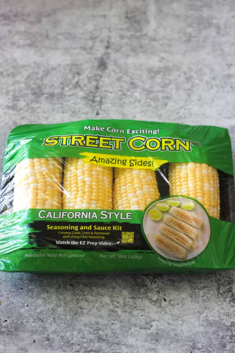 California style street corn with seasoning and lime slices.