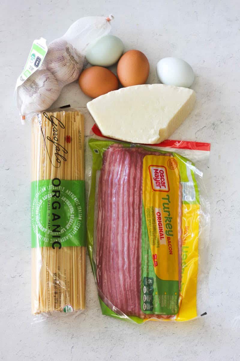 Eggs, garlic, cheese, and pasta ingredients for meal preparation.