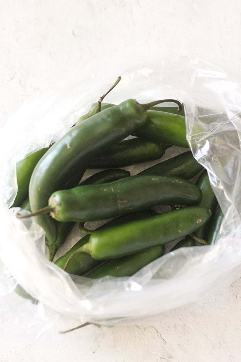 Green jalapeño peppers in a plastic bag for cooking or snacking.
