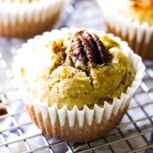 cinnamon muffin with half of pecan on top