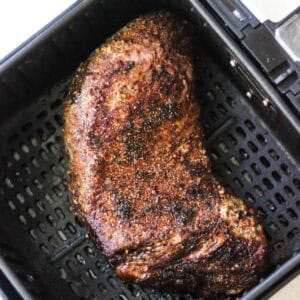 Juicy, well-seared beef brisket with dark bark and crust in air fryer.