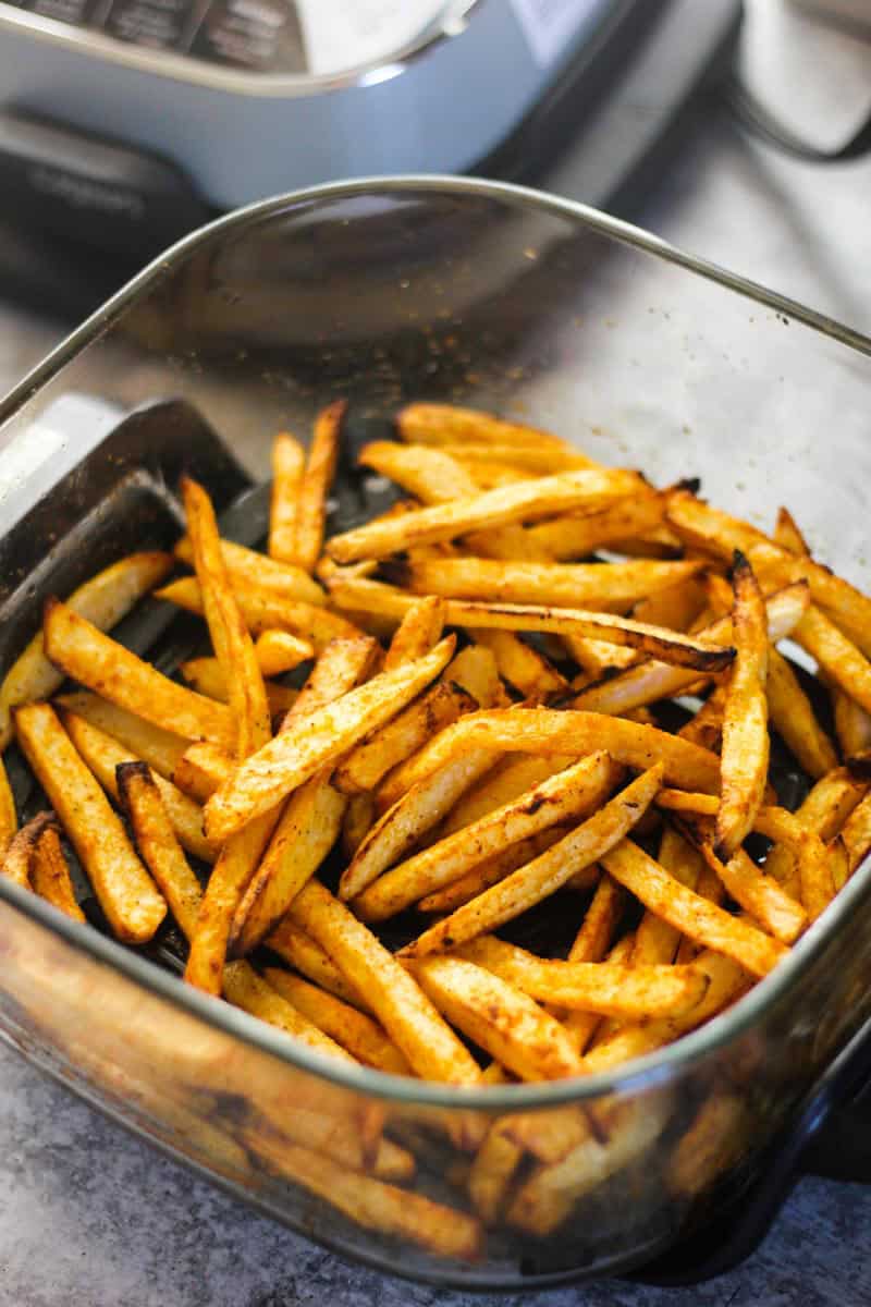 Crispy seasoned french fries in a glass dish from The Top Meal.