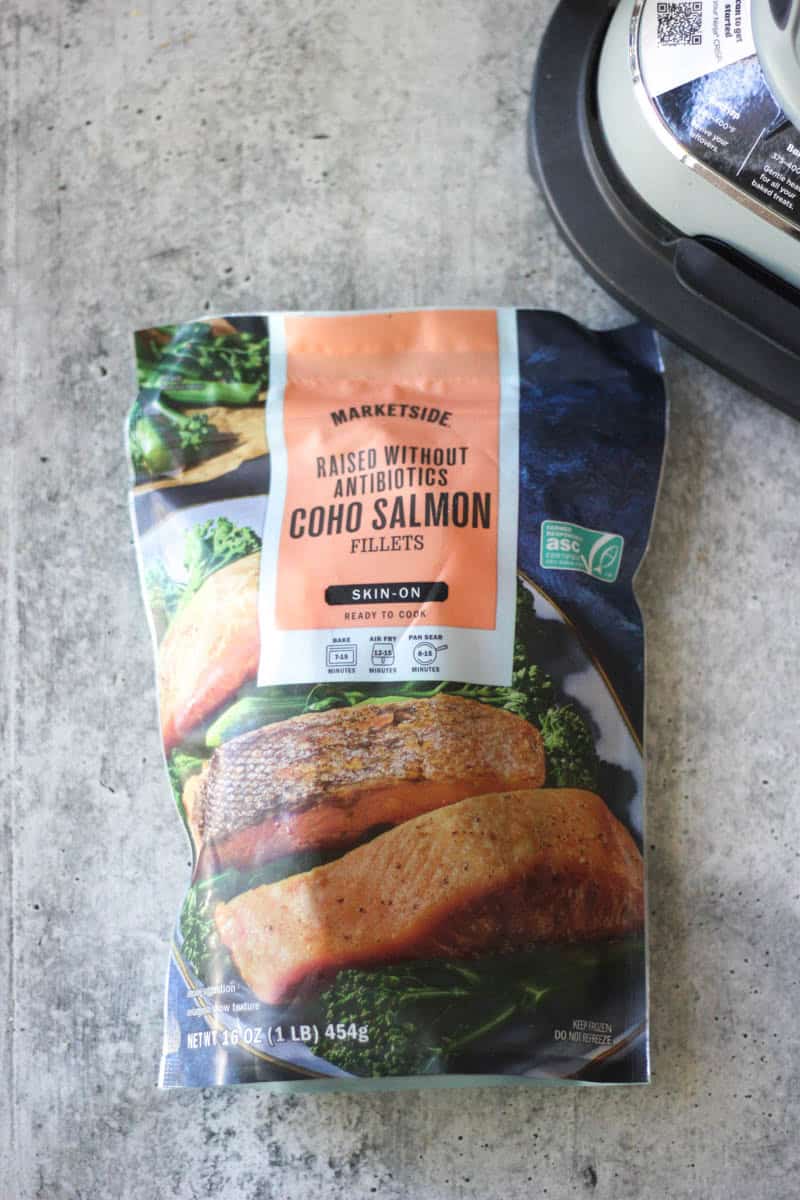 Coho salmon fillets in a bag with greens and cooking scene.