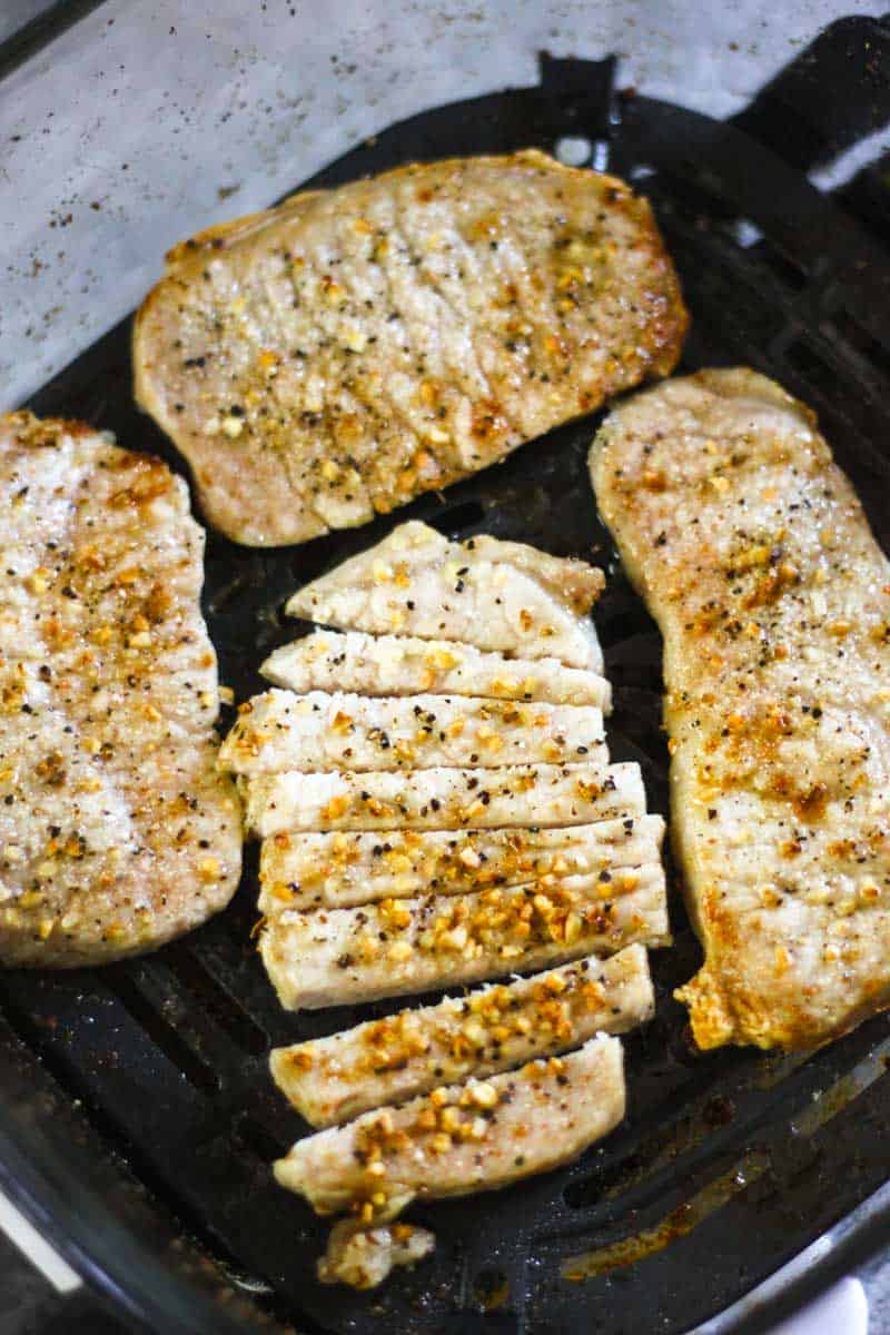Grilled chicken medallions seared with garlic and pepper on a grill pan.