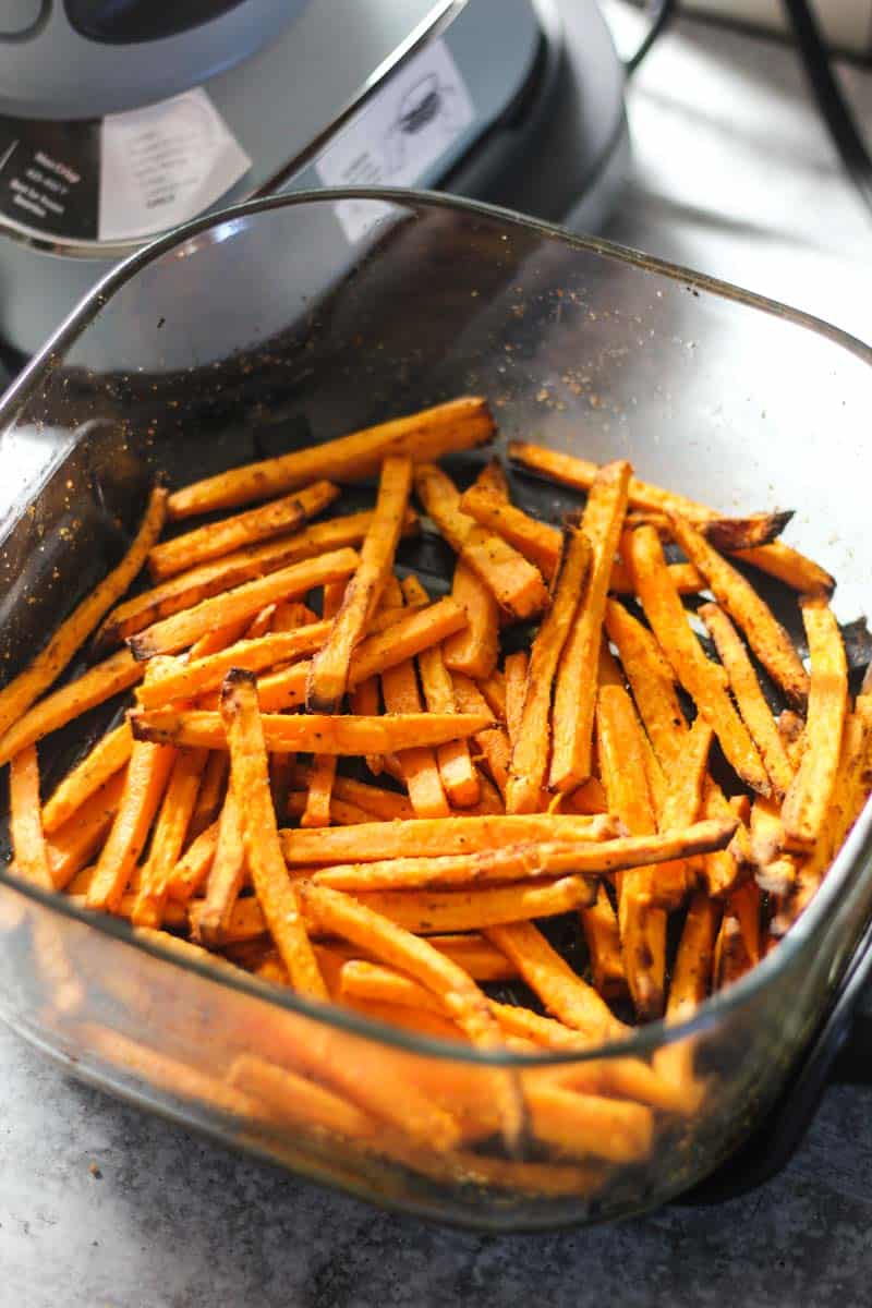 Crispy baked sweet potato fries in a glass bowl ready to serve.