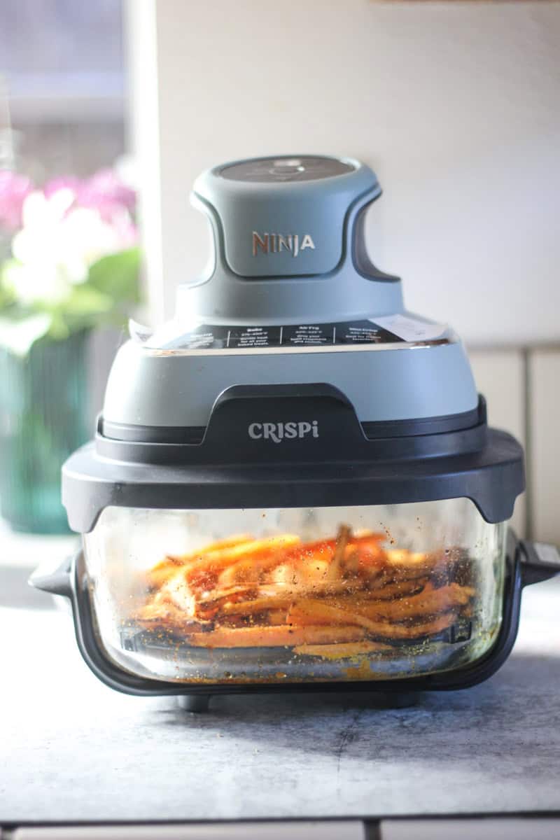 The Top Meal Ninja CRISPI air fryer with crispy fries inside.